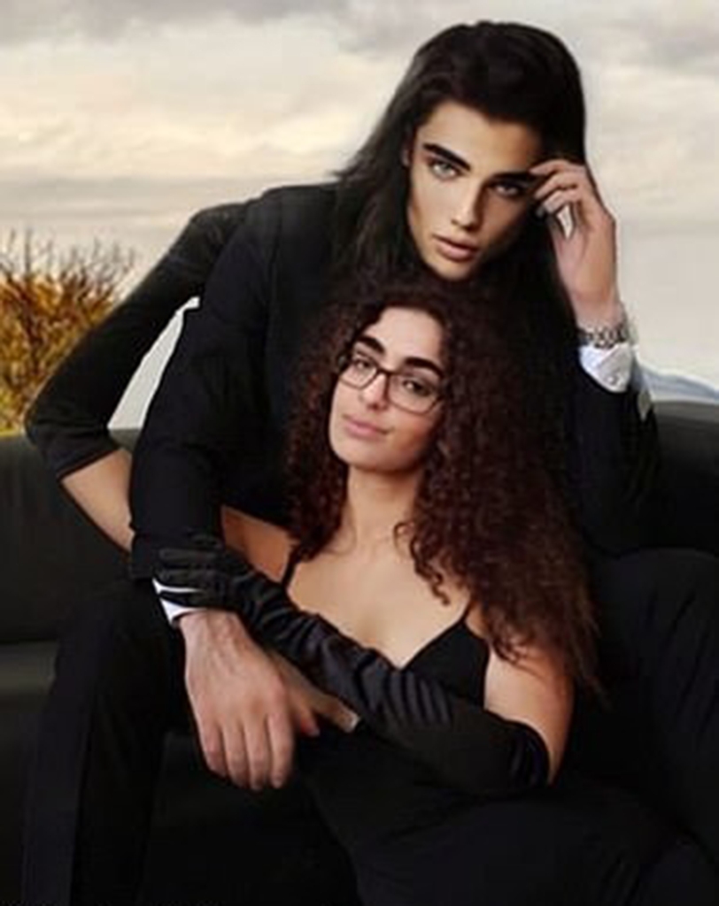 Kartal and Ramos in a digitally rendered image sitting in a field in all black clothing